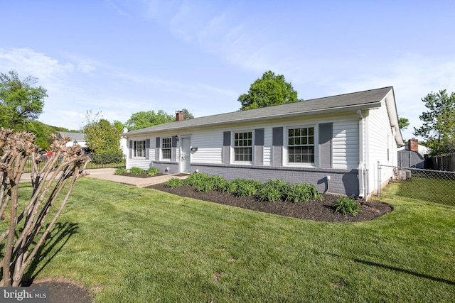 ranch-style house with brick siding, a front lawn, fence, and a chimney