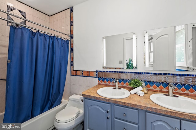751 S Randolph St, Philadelphia, PA 19147 - bathroom with double vanity, shower / tub combo with curtain, tile walls, and decorative backsplash