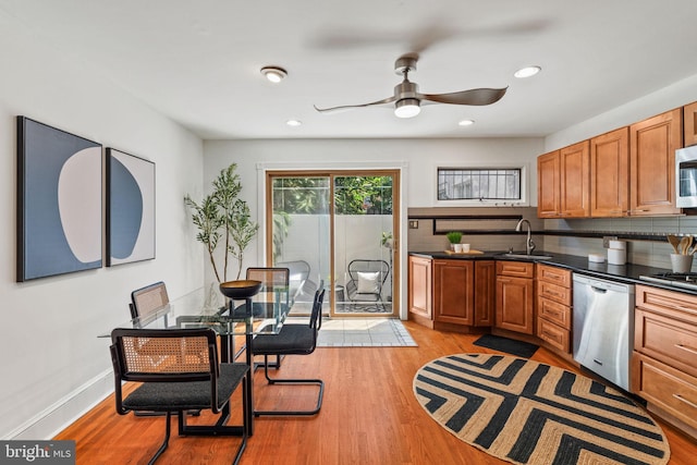 751 S Randolph St, Philadelphia, PA 19147 - kitchen featuring stainless steel appliances, ceiling fan, dark countertops, brown cabinetry, and backsplash