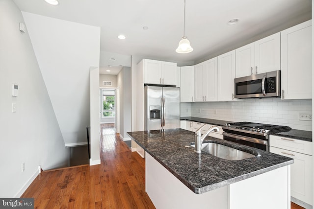 1256 S 27th St, Philadelphia, PA 19146 - kitchen with tasteful backsplash, dark stone countertops, a sink, stainless steel appliances, and baseboards