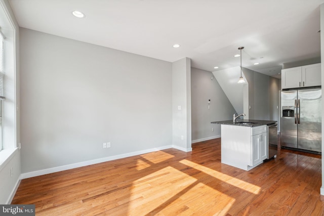 1256 S 27th St, Philadelphia, PA 19146 - kitchen with a sink, baseboards, light wood-style floors, and stainless steel appliances