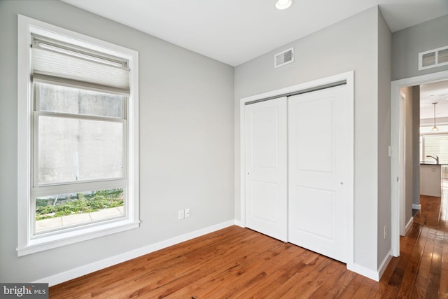 1256 S 27th St, Philadelphia, PA 19146 - unfurnished bedroom with wood finished floors, baseboards, and visible vents