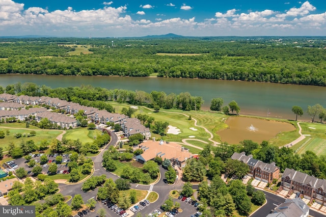 drone / aerial view featuring a water view, a residential view, and a forest view