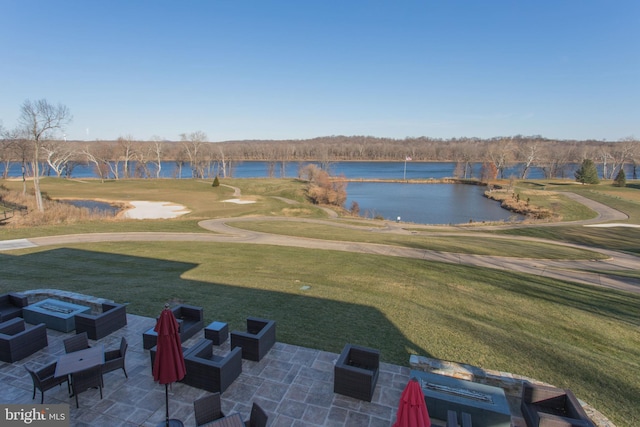 view of community featuring a fire pit, golf course view, a patio, a water view, and a yard
