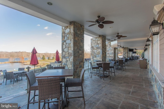 view of patio featuring outdoor dining area and ceiling fan