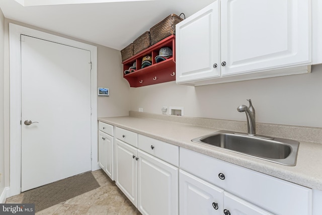 kitchen with white cabinets, open shelves, a sink, and light countertops