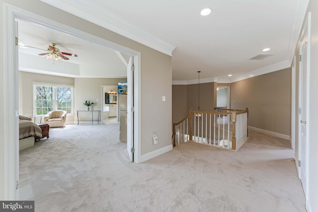corridor featuring crown molding, an upstairs landing, carpet flooring, and baseboards