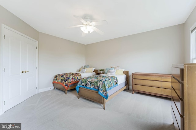 carpeted bedroom with baseboards and a ceiling fan