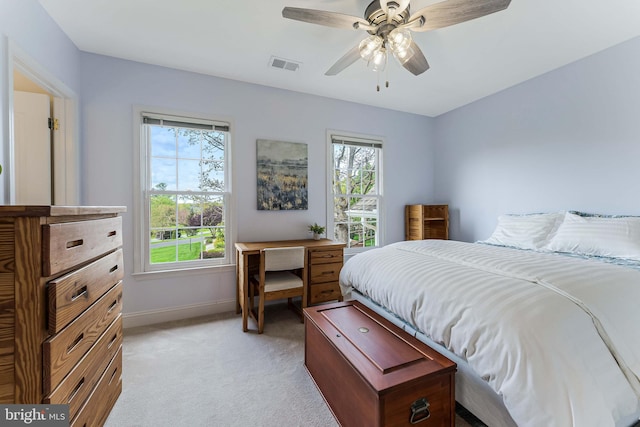 bedroom with light colored carpet, visible vents, ceiling fan, and baseboards