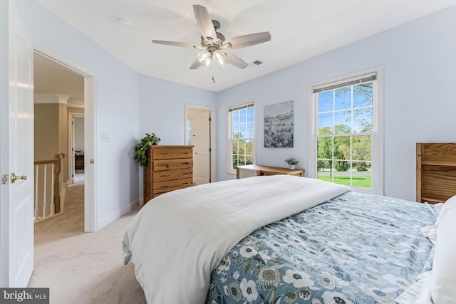 bedroom with a ceiling fan, visible vents, light carpet, and baseboards