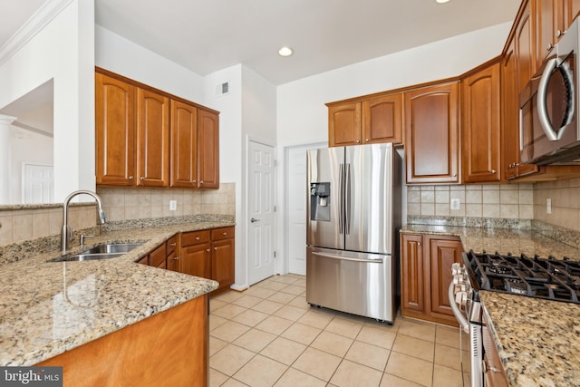 kitchen with light stone counters, light tile patterned floors, visible vents, appliances with stainless steel finishes, and a sink