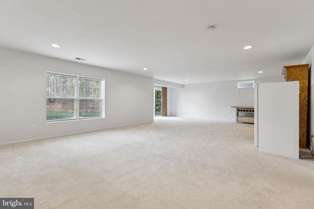 unfurnished room with visible vents, recessed lighting, and light colored carpet