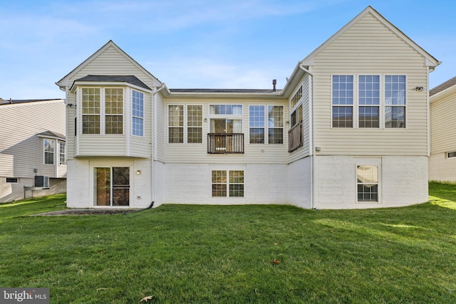rear view of house featuring a yard, brick siding, and cooling unit