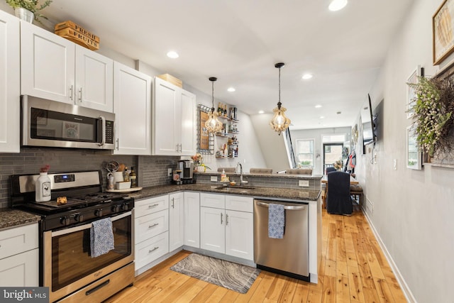 2512 Collins St, Philadelphia, PA 19125 - kitchen featuring backsplash, a sink, a peninsula, appliances with stainless steel finishes, and open floor plan
