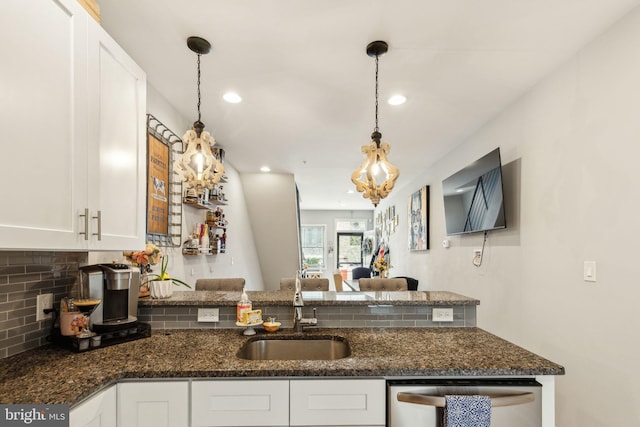 2512 Collins St, Philadelphia, PA 19125 - kitchen with decorative backsplash, stainless steel dishwasher, a sink, and white cabinetry