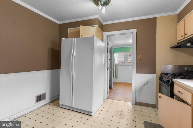 702 Chestnut St, Delanco, NJ 08075 - kitchen with a wainscoted wall, black gas range oven, freestanding refrigerator, under cabinet range hood, and light floors