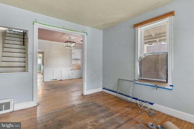 702 Chestnut St, Delanco, NJ 08075 - spare room with visible vents, wood finished floors, a healthy amount of sunlight, and stairway