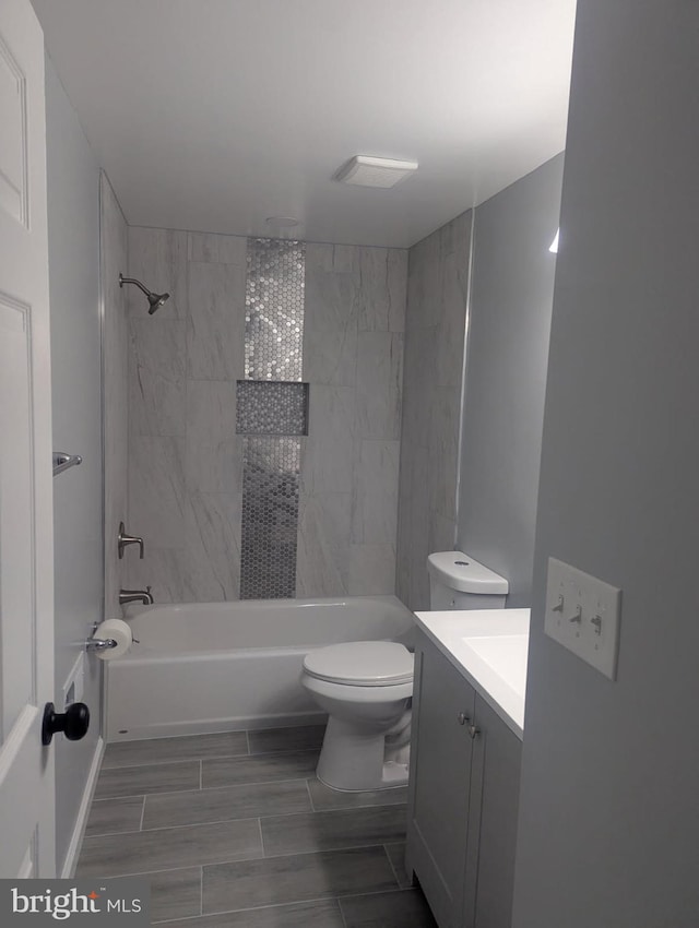 bathroom with toilet, vanity, and shower / bath combination