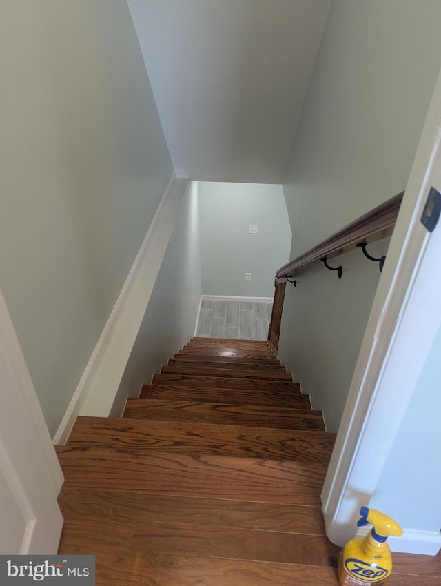 staircase with wood finished floors