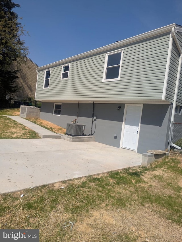 back of property with cooling unit and a patio