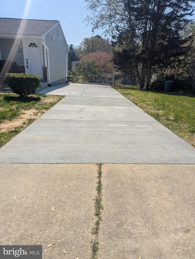 view of home's exterior featuring concrete driveway