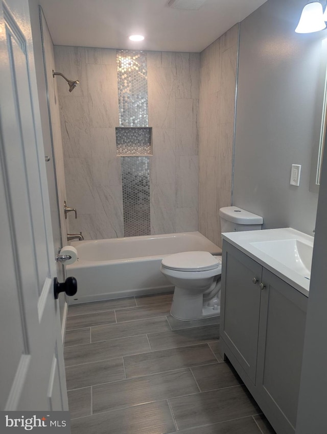full bath featuring shower / bathing tub combination, toilet, vanity, and recessed lighting