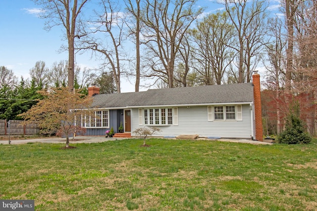 ranch-style house with a front lawn, fence, a patio, a chimney, and board and batten siding
