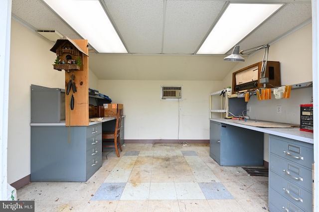 kitchen featuring light countertops, a wall mounted AC, gray cabinetry, and light floors