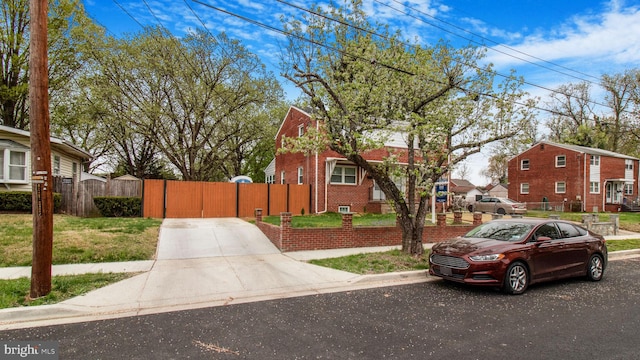 5011 37th Ave, Hyattsville, MD 20782 - view of front of home featuring a residential view, a gate, driveway, brick siding, and fence
