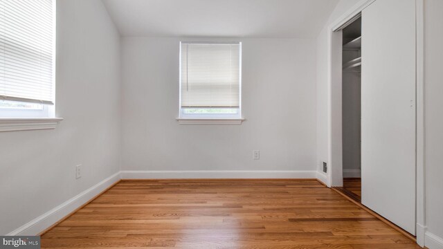5011 37th Ave, Hyattsville, MD 20782 - unfurnished bedroom featuring light wood finished floors, baseboards, and multiple windows