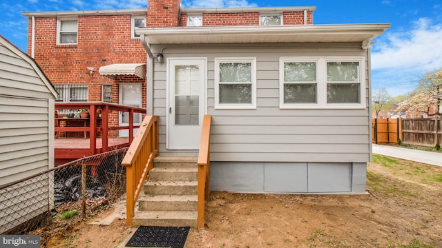 5011 37th Ave, Hyattsville, MD 20782 - rear view of property featuring a wooden deck, fence, and a chimney
