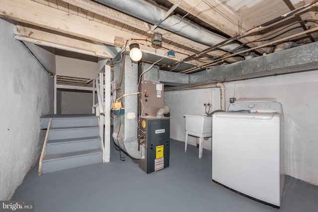 unfinished basement with heating unit, a sink, stairway, and washer / dryer