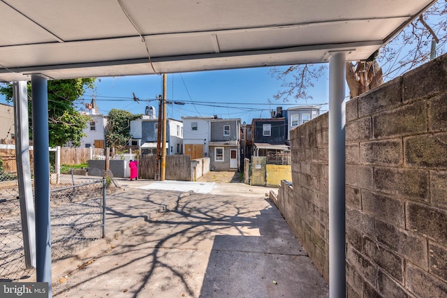 view of patio featuring fence and a residential view