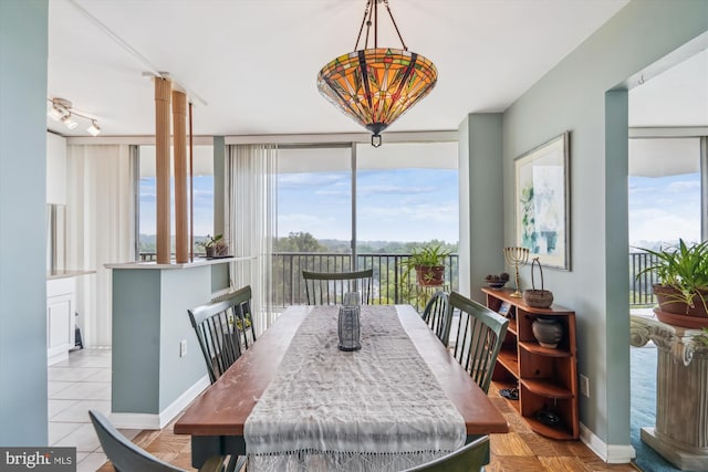 3333 University Blvd W Unit 1102, Kensington, MD 20895 - dining space with healthy amount of natural light, baseboards, ornate columns, and expansive windows