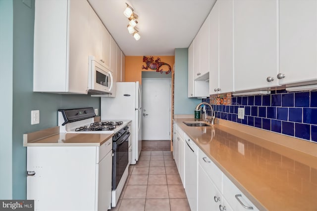3333 University Blvd W Unit 1102, Kensington, MD 20895 - kitchen with white appliances, a sink, light tile patterned floors, and white cabinetry