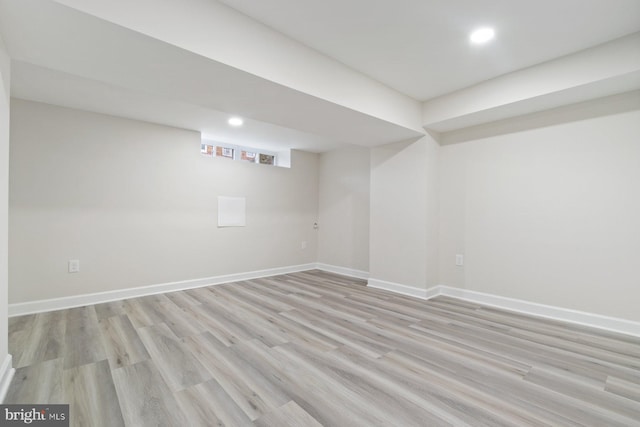 basement featuring recessed lighting, light wood finished floors, and baseboards
