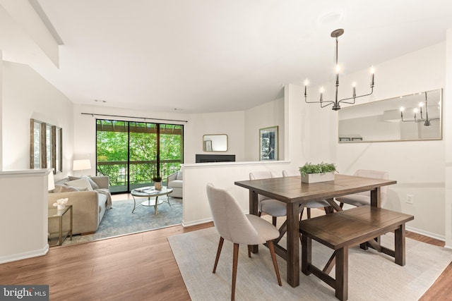 11116 Boathouse Ct Unit 93, Reston, VA 20191 - dining room featuring a chandelier, light wood-style floors, and baseboards