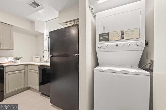 11116 Boathouse Ct Unit 93, Reston, VA 20191 - clothes washing area featuring stacked washer and clothes dryer and light tile patterned floors