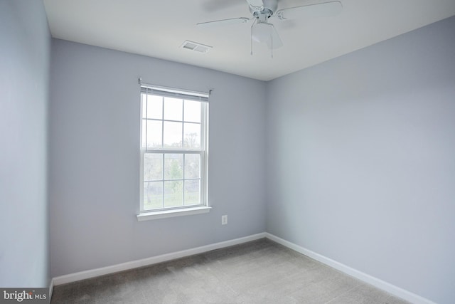 unfurnished room featuring visible vents, ceiling fan, carpet floors, and baseboards