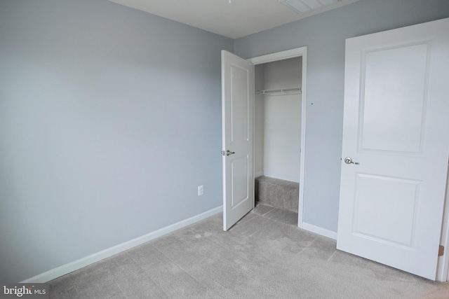unfurnished bedroom with light carpet, a closet, baseboards, and visible vents