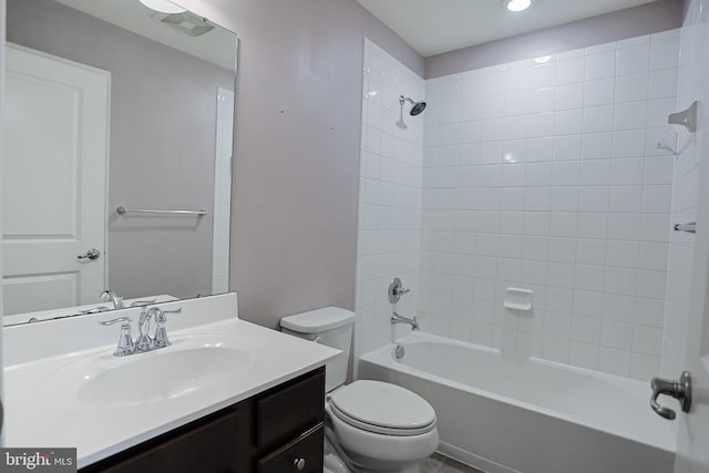bathroom with toilet, vanity, and shower / bathtub combination