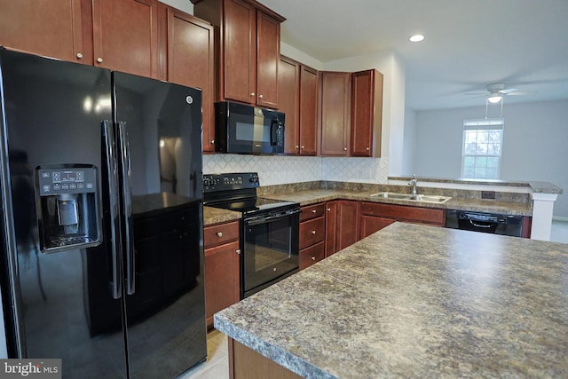 kitchen featuring tasteful backsplash, a peninsula, black appliances, ceiling fan, and a sink