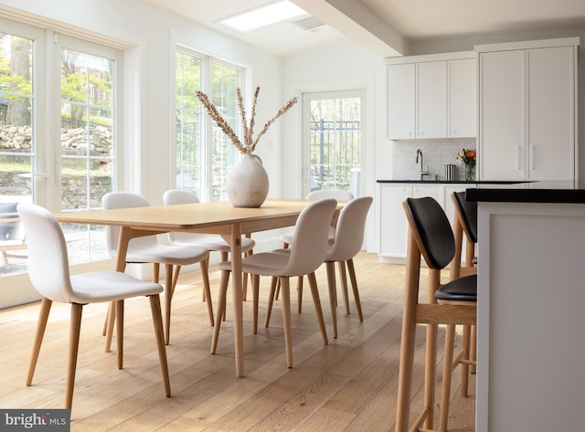 dining area featuring light wood-style flooring