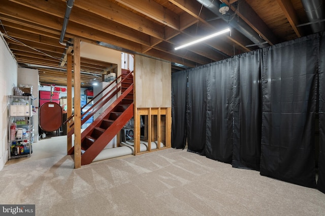unfinished basement featuring stairway