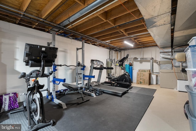 workout area featuring concrete block wall