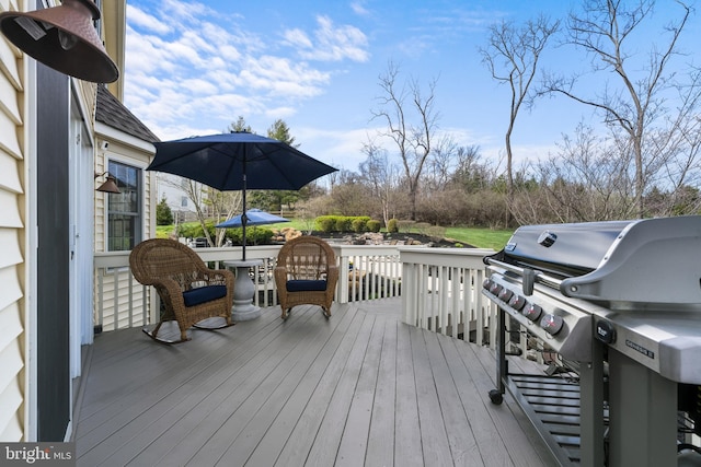 wooden deck with a grill
