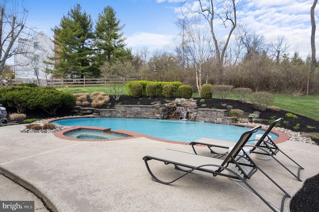 view of pool featuring a patio area, fence, and an in ground hot tub