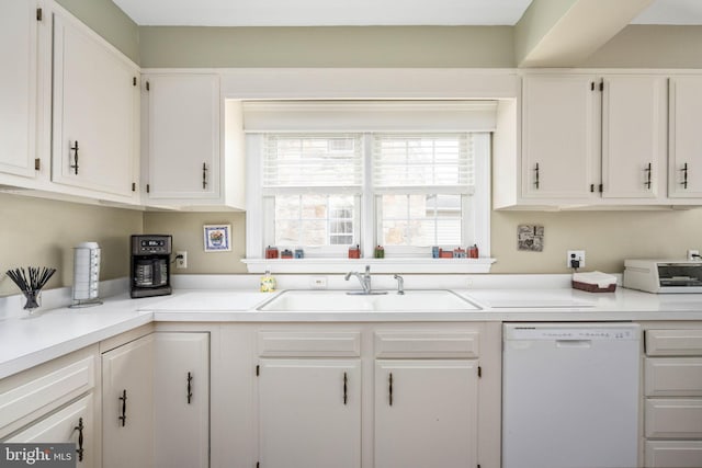 kitchen with light countertops, a toaster, white cabinetry, a sink, and white dishwasher