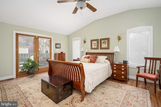 bedroom featuring vaulted ceiling, baseboards, access to exterior, a ceiling fan, and wood finished floors