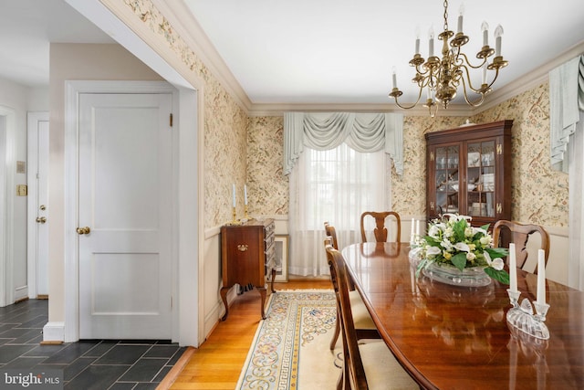 dining area featuring a wainscoted wall, crown molding, a chandelier, wood finished floors, and wallpapered walls